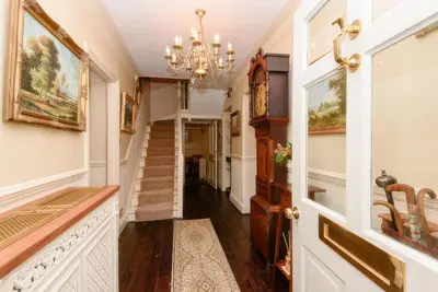 a hallway of a home with a chandelier at Ladye Park in Liskeard