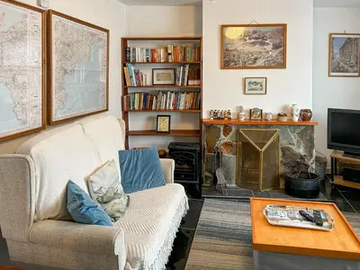 a living room with a couch and a fireplace at Orchard Cottage in Penzance