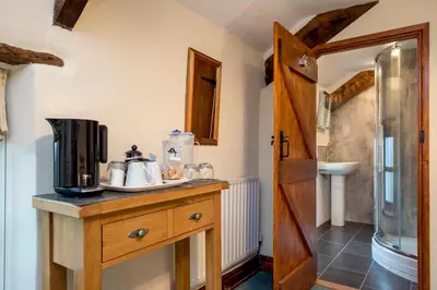 a bathroom with a counter with a coffee maker on it at The White Cottage B&B in Saint Teath