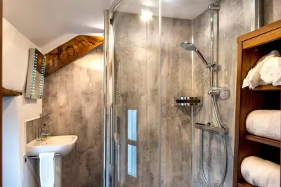 a bathroom with a shower and a sink at The White Cottage B&B in Saint Teath