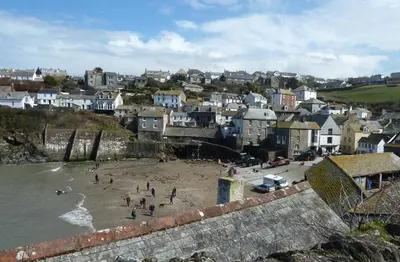 a group of people on a beach near the water at The White Cottage B&B in Saint Teath