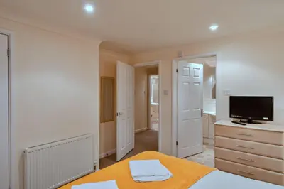 a bedroom with a bed and a flat screen tv at Finest Retreats - 2 Chy Lowen in Newquay