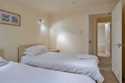two beds sitting next to each other in a bedroom at Finest Retreats - 2 Chy Lowen in Newquay