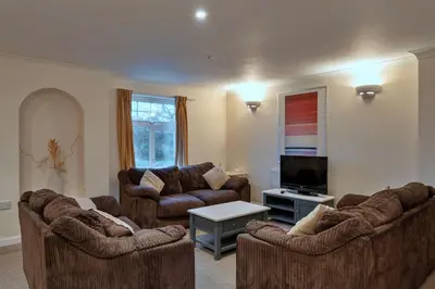 a living room with two couches and a flat screen tv at Finest Retreats - 2 Chy Lowen in Newquay