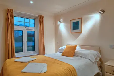 a bedroom with a bed with two towels on it at Finest Retreats - 2 Chy Lowen in Newquay