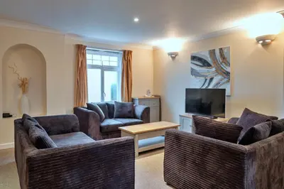 a living room with two couches and a television at Finest Retreats - 20 Chy Lowen in Newquay