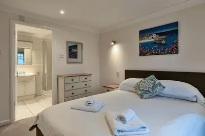 a bedroom with a bed with towels on it at Finest Retreats - Atlantic 55 in Newquay