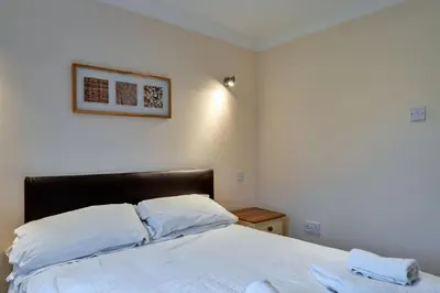 a bedroom with a bed with two white pillows at Finest Retreats - Atlantic 55 in Newquay
