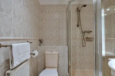 a bathroom with a shower and a toilet and a sink at Finest Retreats - Atlantic 55 in Newquay