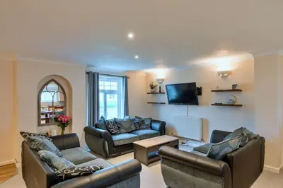 a living room with two couches and a tv at Finest Retreats - Atlantic 55 in Newquay