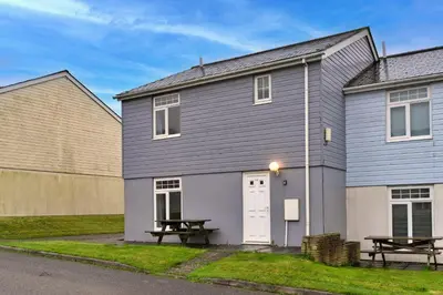 a house with two picnic tables in front of it at Finest Retreats - Atlantic 55 in Newquay