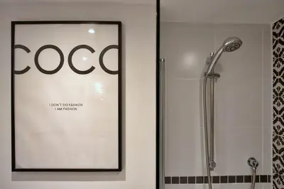 a shower in a bathroom with a framed picture at Finest Retreats - Pobbles Place in Fowey
