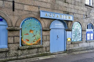 a building with a clock on the side of it at Finest Retreats - Pobbles Place in Fowey