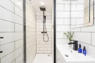 a bathroom with a shower and a sink at Happy Days Cottage - Free WiFi - Minutes from Harbour & Beaches - Pets Welcome in St Ives