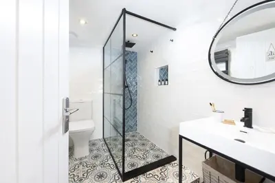 a bathroom with a shower and a sink and a mirror at Happy Days Cottage - Free WiFi - Minutes from Harbour & Beaches - Pets Welcome in St Ives