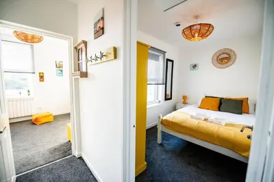 a bedroom with a bed and a window at Seaside Home with Parking Near Tolcarne Beach in Newquay