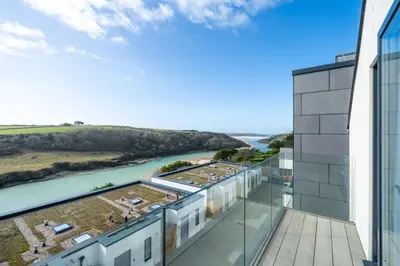 a view from the balcony of a building with a river at Modern Home with Stunning Gannel Estuary Views in Newquay