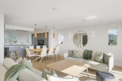 a living room with a couch and a table at Modern Home with Stunning Gannel Estuary Views in Newquay