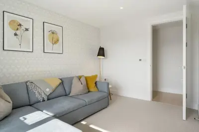 a living room with a blue couch in a room at Modern Home with Stunning Gannel Estuary Views in Newquay