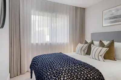 a bedroom with a large bed and a window at Modern Home with Stunning Gannel Estuary Views in Newquay