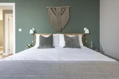a bed with white sheets and pillows in a bedroom at Cloud 10, St Ives - Free WiFi - Free Parking - Pets Welcome - Sea Views in St Ives