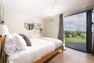 a bedroom with a bed and a large window at Cloud 10, St Ives - Free WiFi - Free Parking - Pets Welcome - Sea Views in St Ives