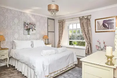 a bedroom with a bed and a window at The Old Farmhouse in Looe