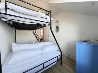 a bedroom with a bunk bed with white pillows at Draycott Dreams in St Ives