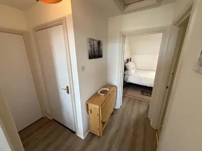 a room with a bedroom with a bed and a mirror at Draycott Dreams in St Ives