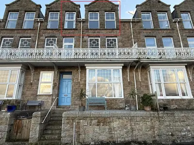 an old brick house with a blue door at Draycott Dreams in St Ives