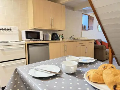 a kitchen with a table with a plate of food on it at Grannys in St Ives in St Ives