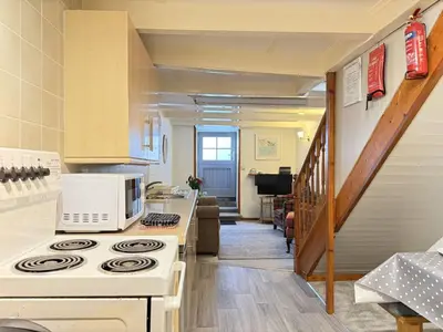 a kitchen with a stove and a microwave at Grannys in St Ives in St Ives