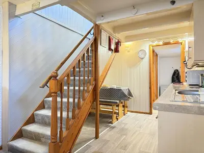 a staircase in a tiny house with a kitchen at Grannys in St Ives in St Ives