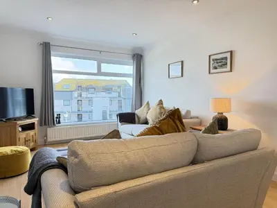 a living room with a couch and a tv at Seaview Clearwater in St Ives