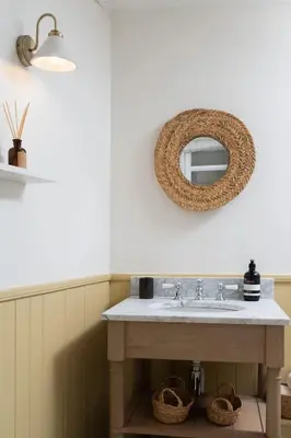 a bathroom with a sink and a mirror on the wall at Traditional Cornish Cottage & Garden Redruth in Redruth