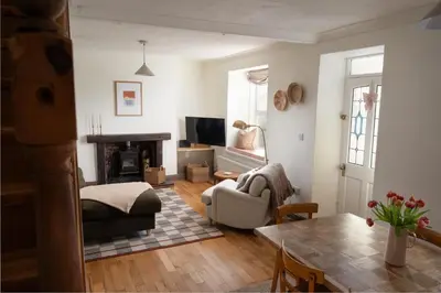 a living room with a couch and a fireplace at Traditional Cornish Cottage & Garden Redruth in Redruth