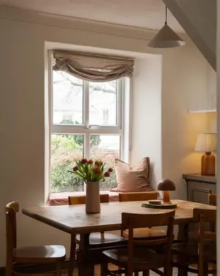 a dining room table with chairs and a window at Traditional Cornish Cottage & Garden Redruth in Redruth