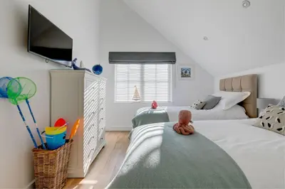a childs bedroom with two beds and a flat screen tv at Sea Vista in Carbis Bay