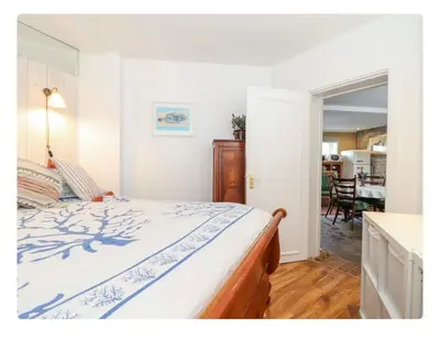 a bedroom with a bed and a dining room at The Hexagon House in Penzance