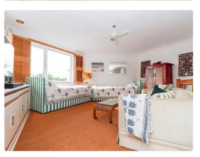 a living room with two couches and a table at The Hexagon House in Penzance
