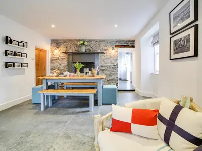 a living room with a table and a couch at Church Hill House in Port Isaac