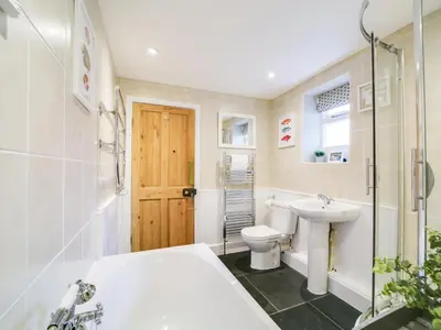 a bathroom with a toilet and a sink at Church Hill House in Port Isaac