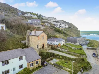 an aerial view of a town with houses on a hill at 3 Bed in Porthtowan oc-e34620 in Porthtowan