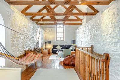 a hammock in a room with a stone wall at 3 Bed in Porthtowan oc-e34620 in Porthtowan