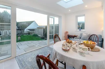 a dining room with a table with a bowl of fruit on it at 2 Bed in Mylor Bridge oc-p34490 in Mylor Bridge