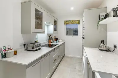 a kitchen with white cabinets and a toaster on the counter at 2 Bed in Mylor Bridge oc-p34490 in Mylor Bridge