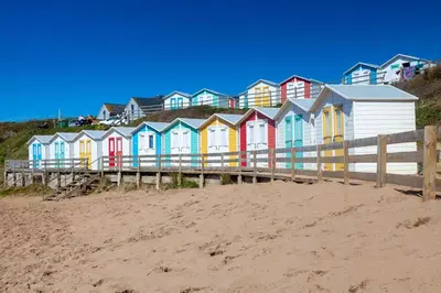 a row of colorful houses on a beach at 1 Bed in St. Gennys oc-c34627 in Crackington Haven