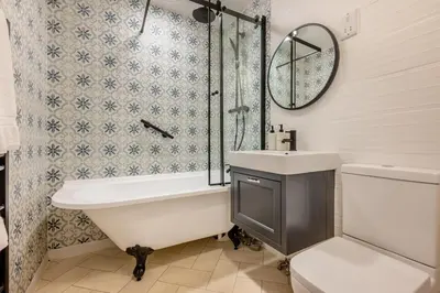 a bathroom with a tub and a sink and a mirror at 1 Bed in St. Gennys oc-c34627 in Crackington Haven