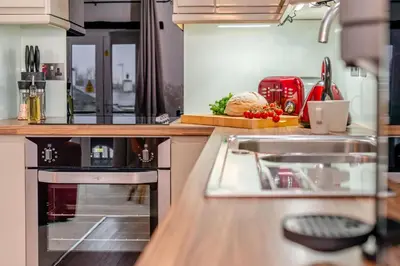 a kitchen with a stove and a counter with food at 1 Bed in St. Gennys oc-l34629 in Crackington Haven