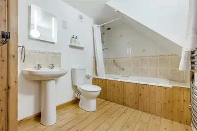 a bathroom with a sink and a toilet and a bath tub at 1 Bed in St. Gennys oc-l34629 in Crackington Haven